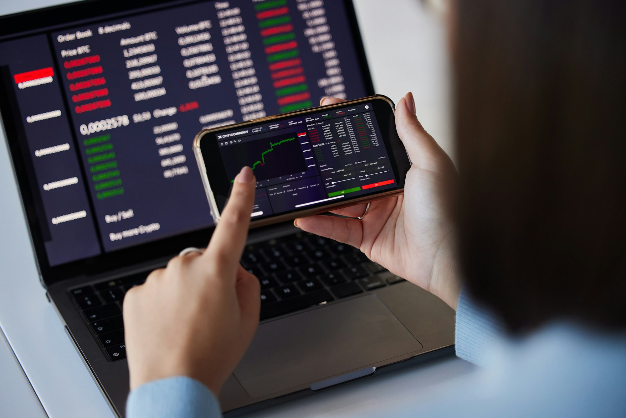 Stock trading chart, laptop and phone in hands of woman for crypto, trading analysis and bitcoin sc